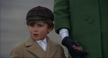 Movie still from “Red Desert” (1964), directed by Michelangelo Antonioni – A young boy wearing a hat and a coat; Close Up shot, Over the shoulder angle