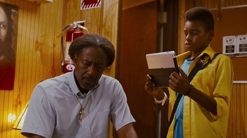 Movie still from “Red Hook Summer” (2012), directed by Spike Lee – A man and a woman are looking at a tablet computer; Medium shot, Over the shoulder angle