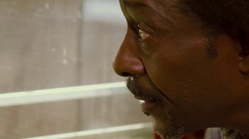 Movie still from “Red Hook Summer” (2012), directed by Spike Lee – A man with a beard looking to his left; Extreme Close Up shot, Over the shoulder angle
