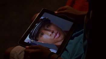 Movie still from “Red Hook Summer” (2012), directed by Spike Lee – A person holding a tablet in their hands; Extreme Close Up shot, Overhead angle
