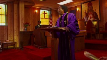 Movie still from “Red Hook Summer” (2012), directed by Spike Lee – A man in a purple robe is giving a sermon; Medium shot, Low angle
