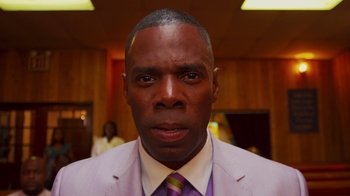 Movie still from “Red Hook Summer” (2012), directed by Spike Lee – A person wearing a suit and tie; Close Up shot, Low angle