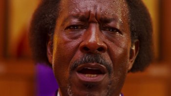 Movie still from “Red Hook Summer” (2012), directed by Spike Lee – An older man with brown hair and a beard; Close Up shot, Low angle