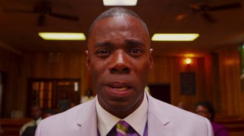 Movie still from “Red Hook Summer” (2012), directed by Spike Lee – A person wearing a suit and tie; Close Up shot, Low angle