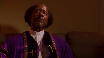 Movie still from “Red Hook Summer” (2012), directed by Spike Lee – A man wearing a purple robe and a cross on his chest; Close Up shot, Low angle