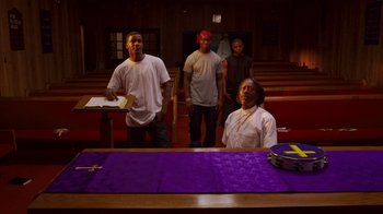 Movie still from “Red Hook Summer” (2012), directed by Spike Lee – A group of men standing in front of an altar; Medium shot, Low angle