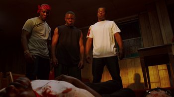 Movie still from “Red Hook Summer” (2012), directed by Spike Lee – A group of men standing in front of a bed; Medium shot, Low angle