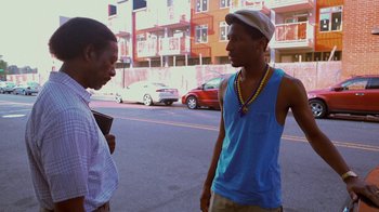 Movie still from “Red Hook Summer” (2012), directed by Spike Lee – Two young men talking on the side of the road; Medium shot, Over the shoulder angle
