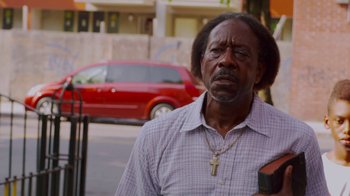 Movie still from “Red Hook Summer” (2012), directed by Spike Lee – A person wearing a shirt; Close Up shot, Low angle