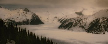 Movie still from “Red Riding Hood” (2011), directed by Catherine Hardwicke – A view of a lake and a snowy mountain; Extreme Wide shot, High angle