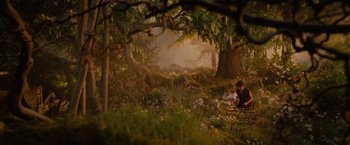 Movie still from “Red Riding Hood” (2011), directed by Catherine Hardwicke – Two people sitting on a bench in the woods; Wide shot, High angle
