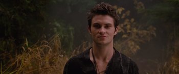 Movie still from “Red Riding Hood” (2011), directed by Catherine Hardwicke – A young man with a beard and a necklace; Close Up shot, Over the shoulder angle