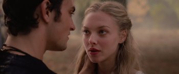 Movie still from “Red Riding Hood” (2011), directed by Catherine Hardwicke – A man and a woman face to face in a forest; Close Up shot, Over the shoulder angle