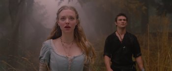 Movie still from “Red Riding Hood” (2011), directed by Catherine Hardwicke – A woman standing next to a man in a field; Close Up shot, Low angle