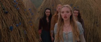 Movie still from “Red Riding Hood” (2011), directed by Catherine Hardwicke – A group of people standing next to each other in a field; Close Up shot, Low angle