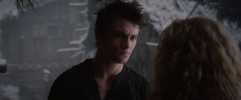 Movie still from “Red Riding Hood” (2011), directed by Catherine Hardwicke – A man with a black shirt is standing next to a woman; Close Up shot, Over the shoulder angle