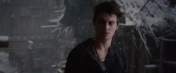 Movie still from “Red Riding Hood” (2011), directed by Catherine Hardwicke – A young man in a black shirt is looking at the camera; Close Up shot, Over the shoulder angle