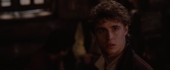 Movie still from “Red Riding Hood” (2011), directed by Catherine Hardwicke – A young man is looking into the camera; Close Up shot, Over the shoulder angle