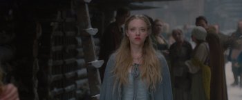 Movie still from “Red Riding Hood” (2011), directed by Catherine Hardwicke – A woman standing in front of a wooden structure; Close Up shot, Over the shoulder angle