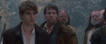 Movie still from “Red Riding Hood” (2011), directed by Catherine Hardwicke – A group of men standing next to each other; Close Up shot, Over the shoulder angle