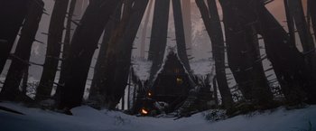 Movie still from “Red Riding Hood” (2011), directed by Catherine Hardwicke – A cabin in the middle of the woods in the snow at night; Extreme Wide shot, Low angle