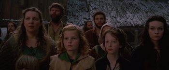 Movie still from “Red Riding Hood” (2011), directed by Catherine Hardwicke – A group of people standing next to each other; Medium shot, Low angle