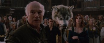 Movie still from “Red Riding Hood” (2011), directed by Catherine Hardwicke – A man standing in front of a group of people with a wolf mask on his head; Close Up shot, Over the shoulder angle