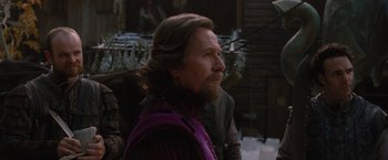Movie still from “Red Riding Hood” (2011), directed by Catherine Hardwicke – A man with long hair and a long beard; Medium shot, Over the shoulder angle