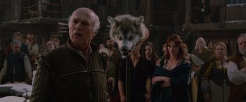 Movie still from “Red Riding Hood” (2011), directed by Catherine Hardwicke – A man standing in front of a group of people; Medium shot, Over the shoulder angle