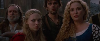 Movie still from “Red Riding Hood” (2011), directed by Catherine Hardwicke – A group of people standing next to each other in a forest; Close Up shot, Low angle