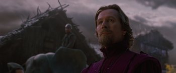 Movie still from “Red Riding Hood” (2011), directed by Catherine Hardwicke – A man with a long beard standing in front of another man; Close Up shot, Low angle