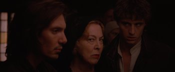 Movie still from “Red Riding Hood” (2011), directed by Catherine Hardwicke – A woman and two other people are looking at something; Close Up shot, Over the shoulder angle