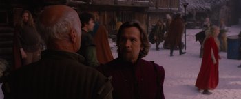 Movie still from “Red Riding Hood” (2011), directed by Catherine Hardwicke – A man with long hair and a beard standing next to another man; Medium shot, Over the shoulder angle