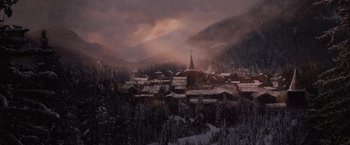 Movie still from “Red Riding Hood” (2011), directed by Catherine Hardwicke – A view of a town in the mountains during a winter storm; Extreme Wide shot, High angle