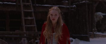 Movie still from “Red Riding Hood” (2011), directed by Catherine Hardwicke – A woman in a red coat standing in the snow; Close Up shot, Over the shoulder angle