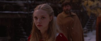 Movie still from “Red Riding Hood” (2011), directed by Catherine Hardwicke – A woman in a red dress looking at the camera; Close Up shot, Over the shoulder angle