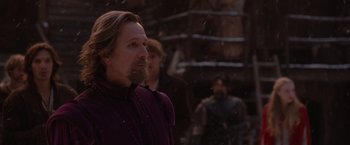 Movie still from “Red Riding Hood” (2011), directed by Catherine Hardwicke – A man with long hair and a goatee standing in the snow; Close Up shot, Over the shoulder angle