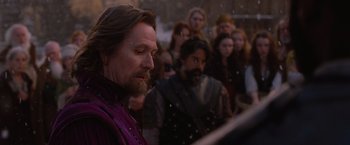 Movie still from “Red Riding Hood” (2011), directed by Catherine Hardwicke – A group of people standing in front of each other; Close Up shot, Over the shoulder angle