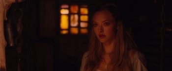 Movie still from “Red Riding Hood” (2011), directed by Catherine Hardwicke – A beautiful young woman standing in front of a stained glass window; Close Up shot, Over the shoulder angle