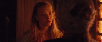 Movie still from “Red Riding Hood” (2011), directed by Catherine Hardwicke – A woman with long blonde hair stares into the camera; Close Up shot, Over the shoulder angle