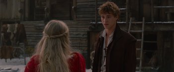 Movie still from “Red Riding Hood” (2011), directed by Catherine Hardwicke – A man and a woman standing next to each other in front of a building; Close Up shot, Over the shoulder angle