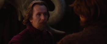 Movie still from “Red Riding Hood” (2011), directed by Catherine Hardwicke – A man with long hair and a goatee stares into the camera; Close Up shot, Over the shoulder angle