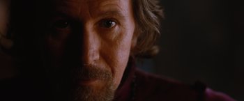 Movie still from “Red Riding Hood” (2011), directed by Catherine Hardwicke – A man with a beard looking at the camera; Close Up shot, Low angle