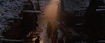 Movie still from “Red Riding Hood” (2011), directed by Catherine Hardwicke – A group of people walking down a snow covered path; Wide shot, Low angle
