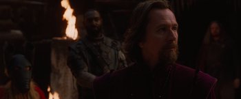 Movie still from “Red Riding Hood” (2011), directed by Catherine Hardwicke – A man with long hair and a beard standing next to a man with a beard; Close Up shot, Over the shoulder angle