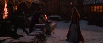 Movie still from “Red Riding Hood” (2011), directed by Catherine Hardwicke – A man and a woman standing in front of a fire pit; Wide shot, Over the shoulder angle