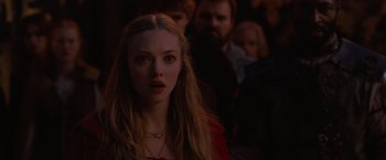 Movie still from “Red Riding Hood” (2011), directed by Catherine Hardwicke – A woman in a red dress is in front of a group of people; Close Up shot, Over the shoulder angle