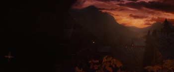 Movie still from “Red Riding Hood” (2011), directed by Catherine Hardwicke – The sun is setting in the dark sky over a mountain; Extreme Wide shot, Low angle