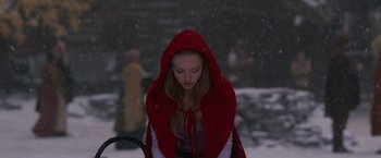 Movie still from “Red Riding Hood” (2011), directed by Catherine Hardwicke – A woman in a red hooded cape in the snow; Medium shot, High angle