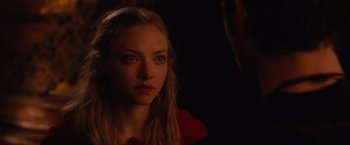 Movie still from “Red Riding Hood” (2011), directed by Catherine Hardwicke – A woman with long blonde hair stares into the camera; Close Up shot, Over the shoulder angle